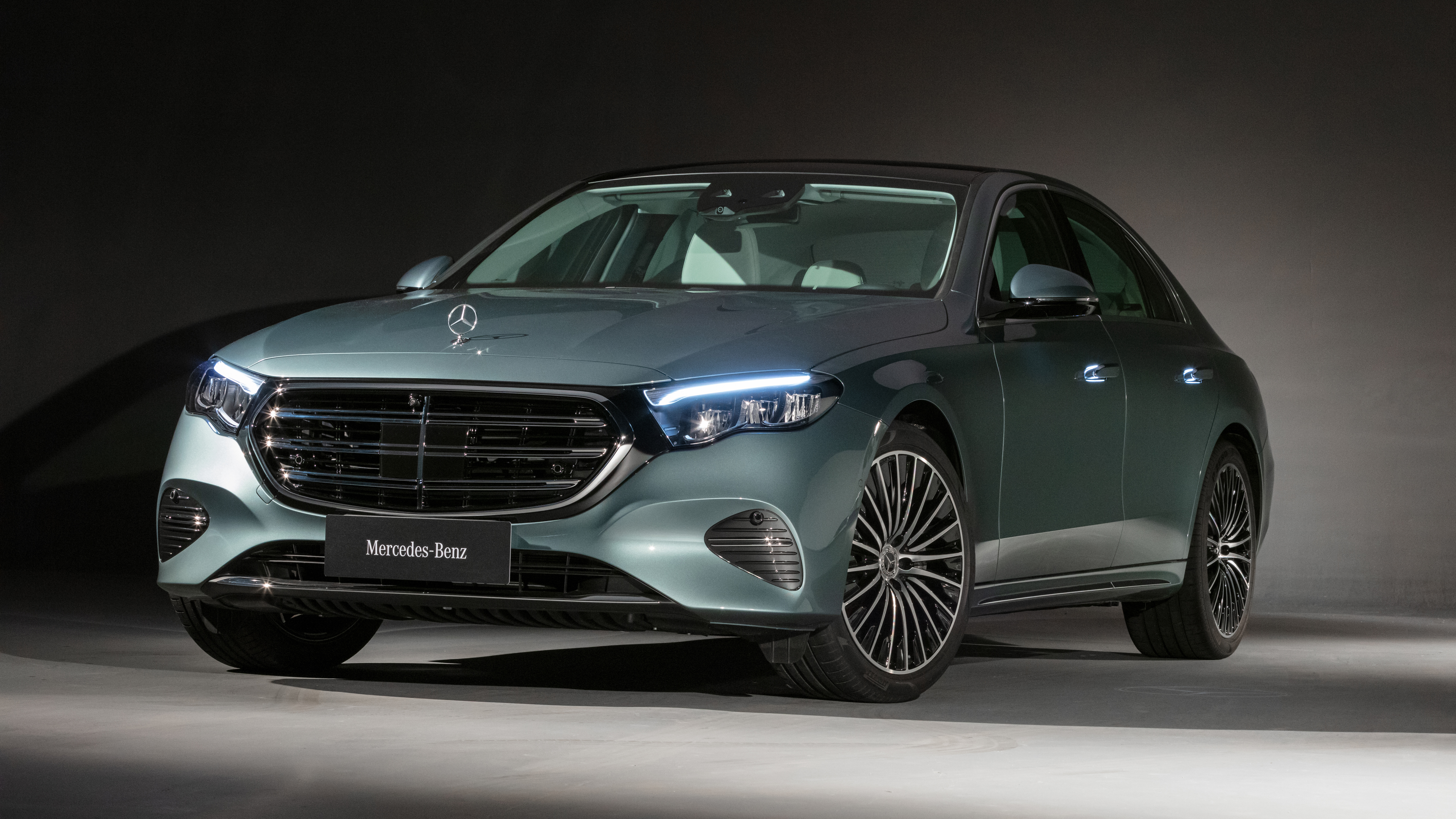 Sleek Teal Mercedes-Benz Sedan with Illuminated Features