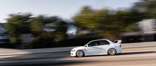 A detailed view of a Mitsubishi Lancer Evolution IX sports sedan. UWUHD free hd wallpapers