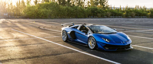 A close-up shot of a luxury Lamborghini sports car showcasing its aerodynamic silhouette. UWUHD free background