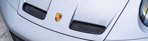A high-performance Porsche GT3 RS sports car showcasing its sleek aerodynamic design. Dual UHD desktop wallpaper