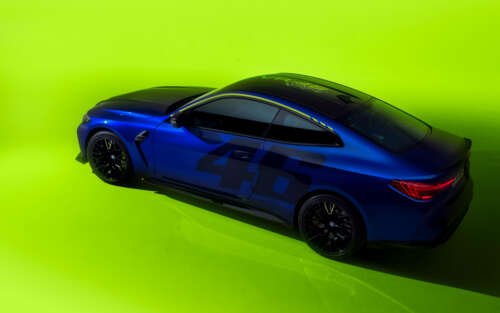 A sleek BMW M4 CS Edition featuring the yellow and black VR46 Valentino Rossi racing... 7680x4800 desktop wallpaper