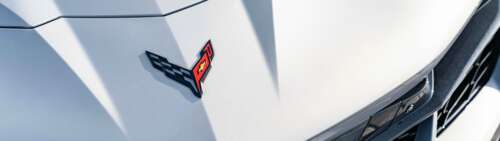 A sleek and aerodynamic Chevrolet Corvette C8 sports car showcasing its mid-engine... Dual UHD pictures for wallpaper