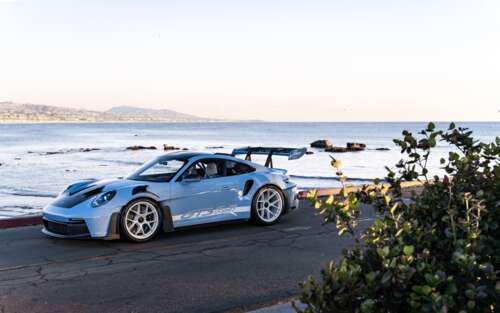 A high-performance Porsche sports car with a sleek, aerodynamic design. 7680x4800 wallpaper download