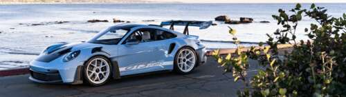 A high-performance Porsche sports car with a sleek, aerodynamic design. Dual UHD wallpaper download