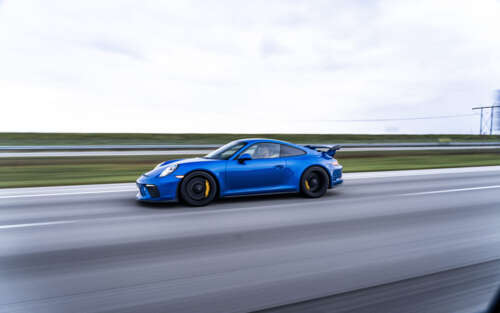 A high-detail shot of a Porsche GT3 RS sports car featuring its iconic aerodynamic... 7680x4800 free wallpaper for computer