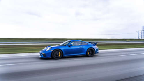 A high-detail shot of a Porsche GT3 RS sports car featuring its iconic aerodynamic... 4K (Ultra HD) free hd wallpapers