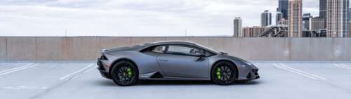 A sleek and powerful Lamborghini Huracán supercar displayed in a professional setting. Dual UHD wallpaper images