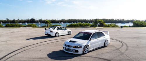 A detailed view of a Mitsubishi Lancer Evolution IX sports sedan showcasing its aerodynamic... UWUHD wallpaper for laptop download