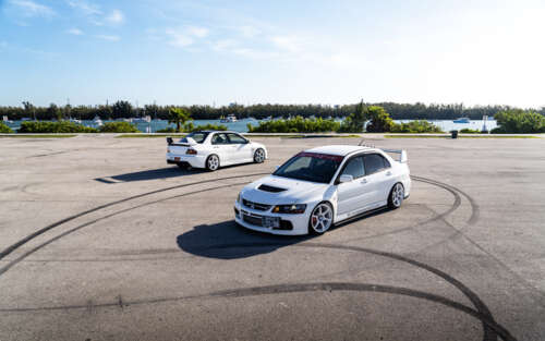 A detailed view of a Mitsubishi Lancer Evolution IX sports sedan showcasing its aerodynamic... 7680x4800 wallpaper for pc download