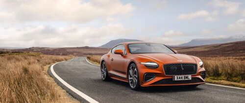 A vibrant orange Bentley Continental GT Speed showcasing its luxurious design and... UWUHD background images hd