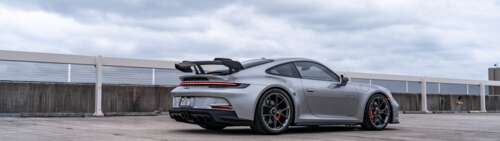 A high-performance Porsche GT3 RS sports car featuring aerodynamic styling and a... Dual UHD hd background