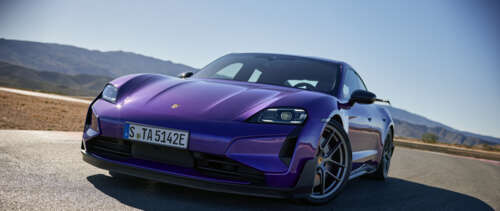 A professional shot of a sleek Porsche Taycan Turbo S electric luxury car. UWUHD wallpaper for laptop download