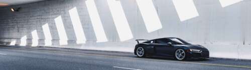 A close-up view of a sleek, modern Audi luxury car showcasing its elegant lines and... Dual UHD desktop wallpaper