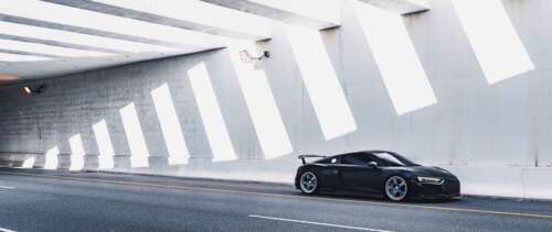 A close-up view of a sleek, modern Audi luxury car showcasing its elegant lines and... UWUHD