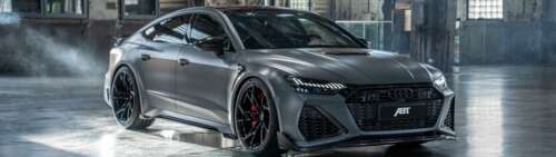 A high-performance Audi RS7 sedan with a sleek, metallic body and aggressive front... Dual UHD free background
