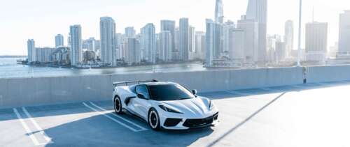 A high-performance Chevrolet Corvette C8 sports car featuring a modern aerodynamic... UWUHD high definition wallpaper
