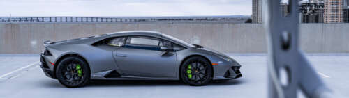 A close-up view of a powerful Lamborghini Huracan sports car highlighting its aerodynamic... Dual UHD wallpaper images