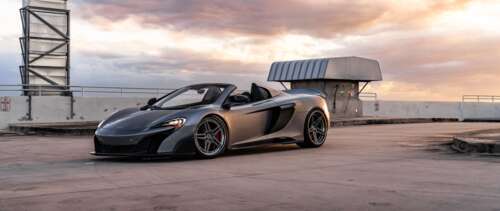 A sleek and aerodynamic McLaren supercar captured in a high-detail shot. UWUHD free background images