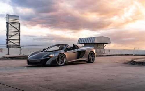 A sleek and aerodynamic McLaren supercar captured in a high-detail shot. 7680x4800 high definition wallpaper