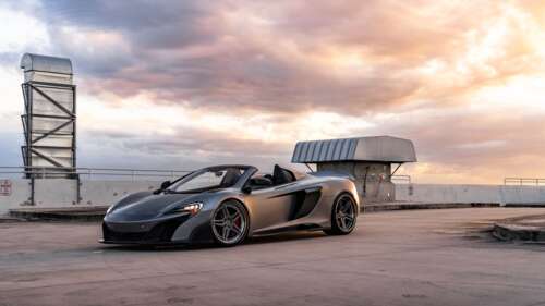 A sleek and aerodynamic McLaren supercar captured in a high-detail shot. 4K (Ultra HD) free background images