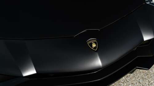 A sleek and aerodynamic Lamborghini supercar featuring a polished-metallic exterior... 8K high definition wallpaper