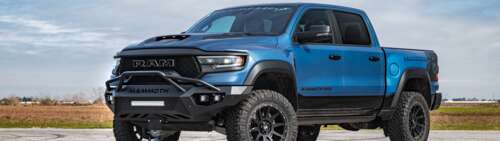 A massive, lifted Hennessey Mammoth 1000 Dodge Ram truck with aggressive off-road... Dual UHD free background