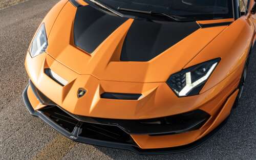 A sleek and powerful Lamborghini Aventador SVJ supercar featuring aggressive aerodynamic... 7680x4800 ps4 wallpaper
