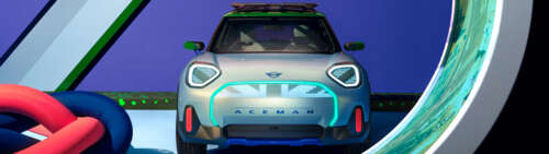 A high-resolution shot of a MINI Aceman electric vehicle showcasing its sleek, modern... Dual UHD wallpaper