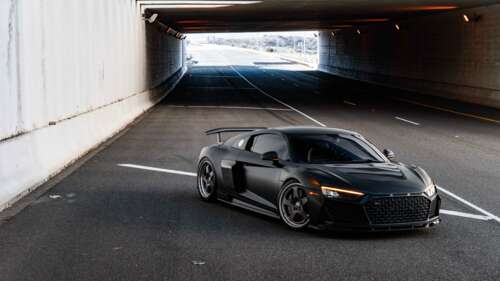 A close-up view of a sleek and modern Audi luxury car with a polished exterior. 8K
