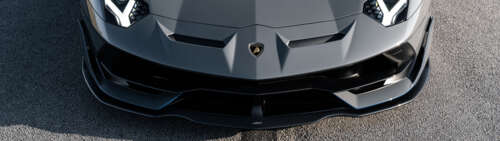 A close-up view of a sleek, high-performance Lamborghini Huracan supercar. Dual UHD high definition wallpaper