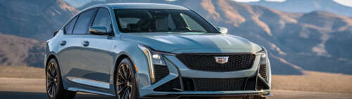 A detailed view of a Cadillac CT5-V Blackwing sedan, emphasizing its modern grille,... Dual UHD free hd wallpapers