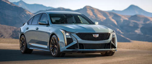 A detailed view of a Cadillac CT5-V Blackwing sedan, emphasizing its modern grille,... UWUHD hd background
