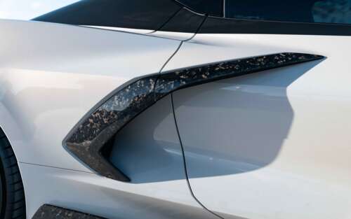 A sleek and powerful Chevrolet Corvette C8 sports car showcasing its aerodynamic... 7680x4800 wallpaper