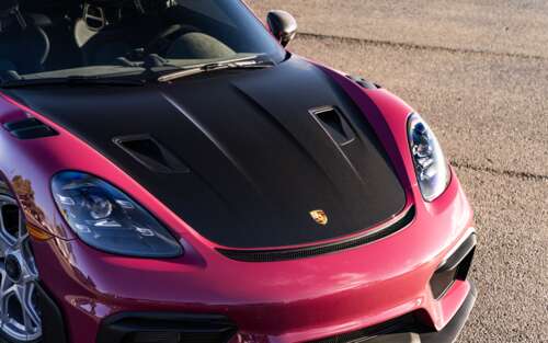 A high-detail shot of a sleek Porsche sports car reflecting light. 7680x4800 free wallpaper for computer