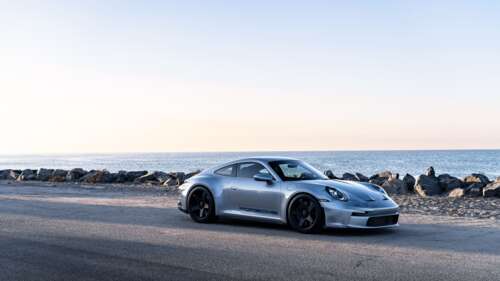 A high-resolution close-up of a Porsche GT3 RS sports car. 8K wallpaper download