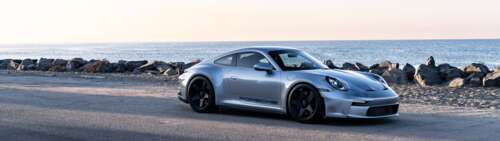 A high-resolution close-up of a Porsche GT3 RS sports car. Dual UHD free wallpaper