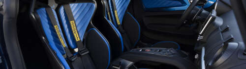Close-up view of the driver's cockpit and interior details of an Alpine A110 R Ultime... Dual UHD free background
