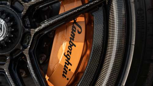 A high-detail shot of a Lamborghini Aventador SVJ supercar featuring its iconic aerodynamic... 8K wallpaper for pc download