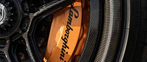A high-detail shot of a Lamborghini Aventador SVJ supercar featuring its iconic aerodynamic... UWUHD computer backgrounds