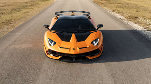 A close-up view of a Lamborghini Aventador SVJ, featuring its sleek aerodynamic bodywork... 4K (Ultra HD) ps4 wallpaper