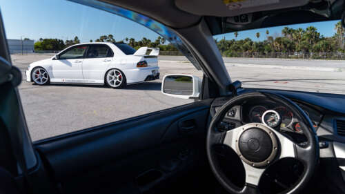 A detailed view of a Mitsubishi Lancer Evolution IX sports car. 8K free hd wallpapers