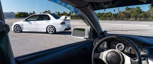 A detailed view of a Mitsubishi Lancer Evolution IX sports car. UWUHD wallpaper images