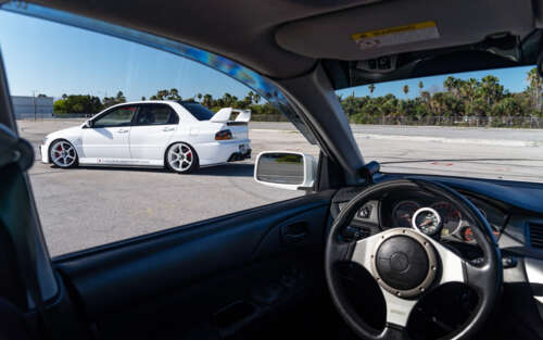 A detailed view of a Mitsubishi Lancer Evolution IX sports car. 7680x4800 free desktop wallpaper