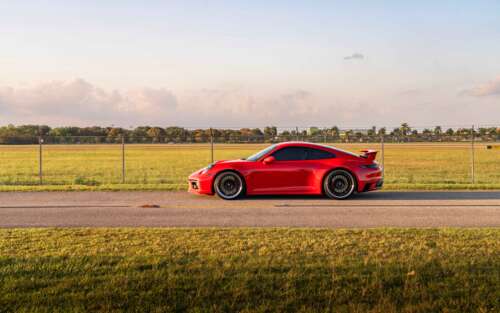 A detailed view of a sleek and powerful Porsche 992 GTS sports car showcasing its... 7680x4800 free background