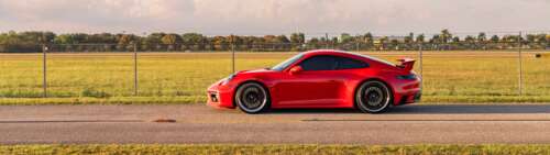 A detailed view of a sleek and powerful Porsche 992 GTS sports car showcasing its... Dual UHD wallpaper photo gallery download