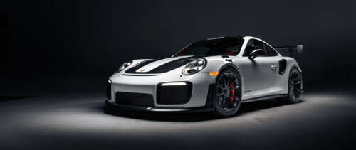 A high-performance Porsche 911 GT2 RS Weissach sports car featuring aggressive aerodynamic... UWUHD wallpaper images