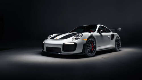 A high-performance Porsche 911 GT2 RS Weissach sports car featuring aggressive aerodynamic... 8K free hd wallpapers