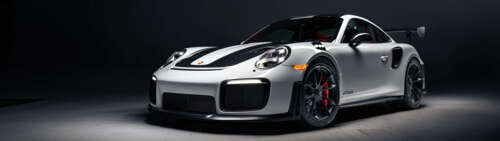 A high-performance Porsche 911 GT2 RS Weissach sports car featuring aggressive aerodynamic... Dual UHD wallpaper download