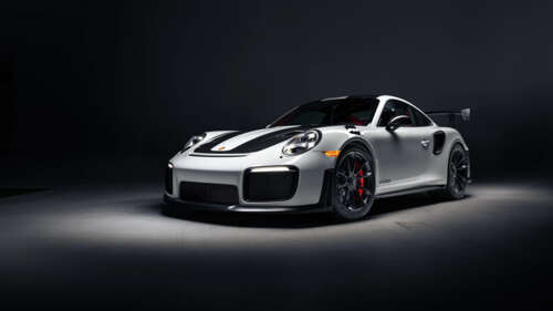 A high-performance Porsche 911 GT2 RS Weissach sports car featuring aggressive aerodynamic... 4K (Ultra HD) high definition wallpaper