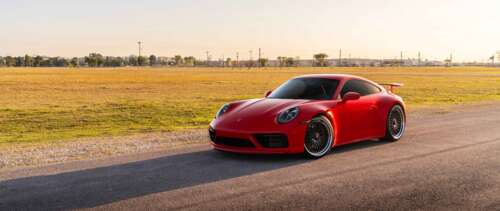A sleek Porsche 992 GTS sports car featuring a polished exterior and iconic design. UWUHD free wallpaper for computer